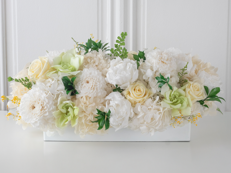 Preserved floral arrangement with white and light green flowers on a white background. For M/Y Vertige